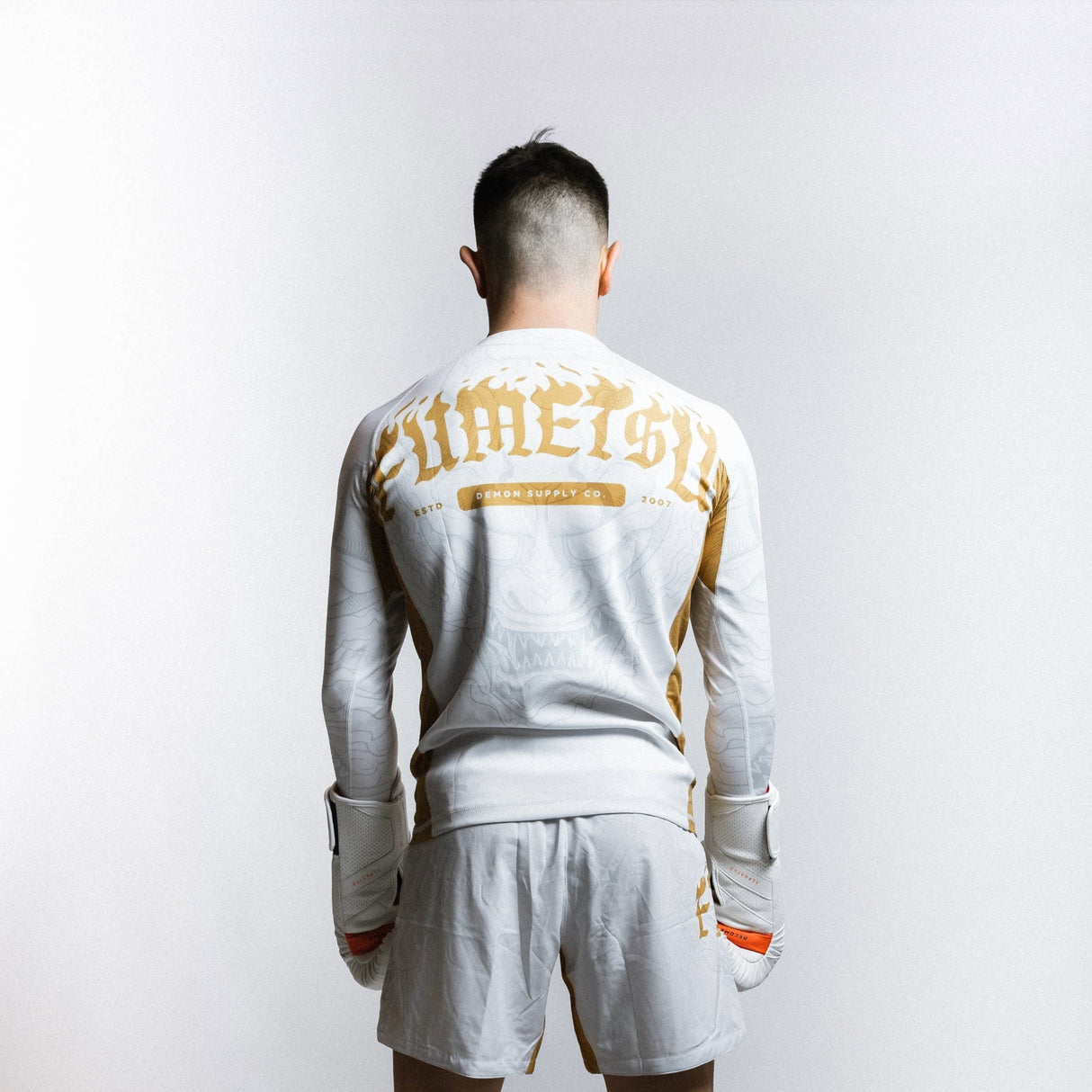 Fumetsu Oni Long Sleeve Rash Guard White/Gold/Grey at Bytomic Trade and Wholesale