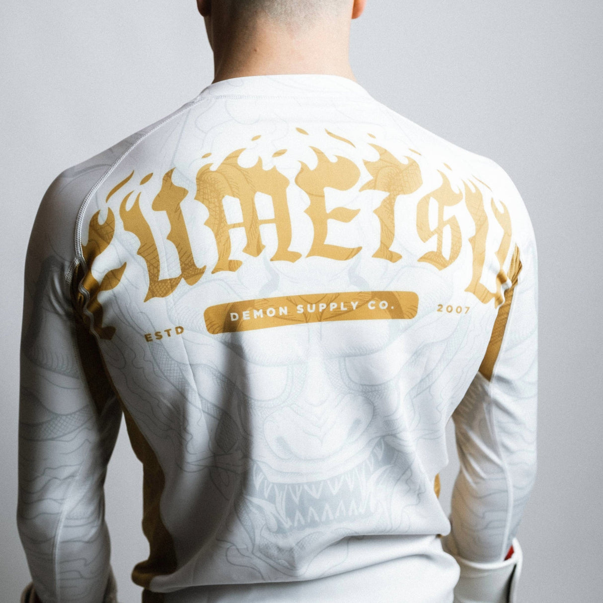 Fumetsu Oni Long Sleeve Rash Guard White/Gold/Grey at Bytomic Trade and Wholesale