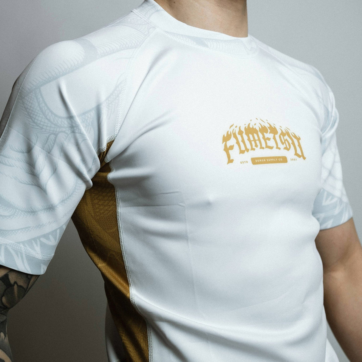 Fumetsu Oni Short Sleeve Rash Guard White/Gold/Grey at Bytomic Trade and Wholesale